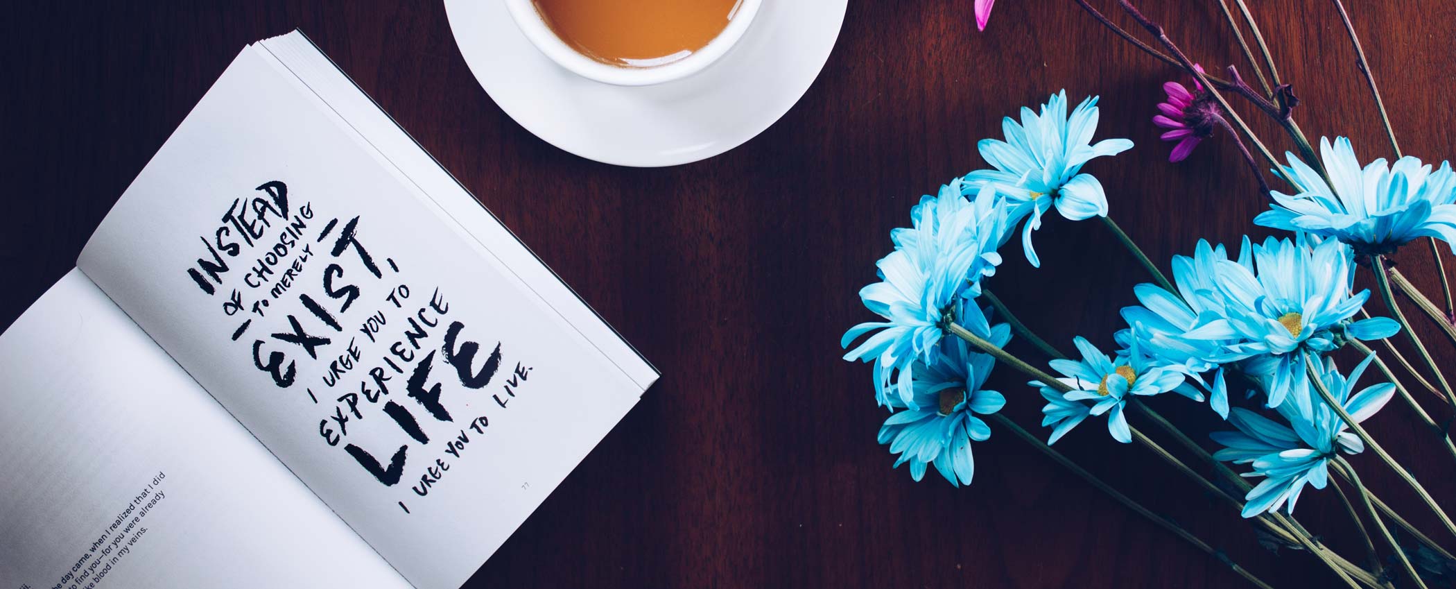 book and flowers on a table